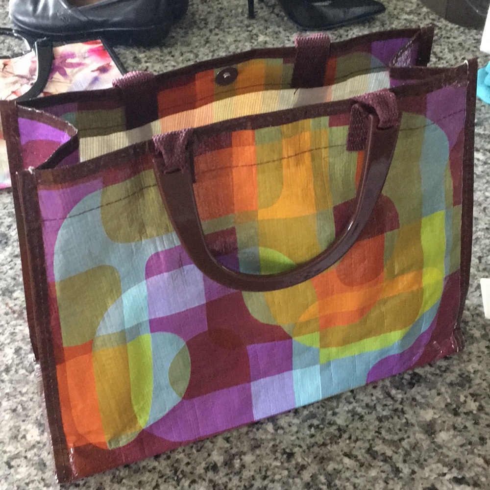 Multicolored Blue Q handbag with plastic handles.